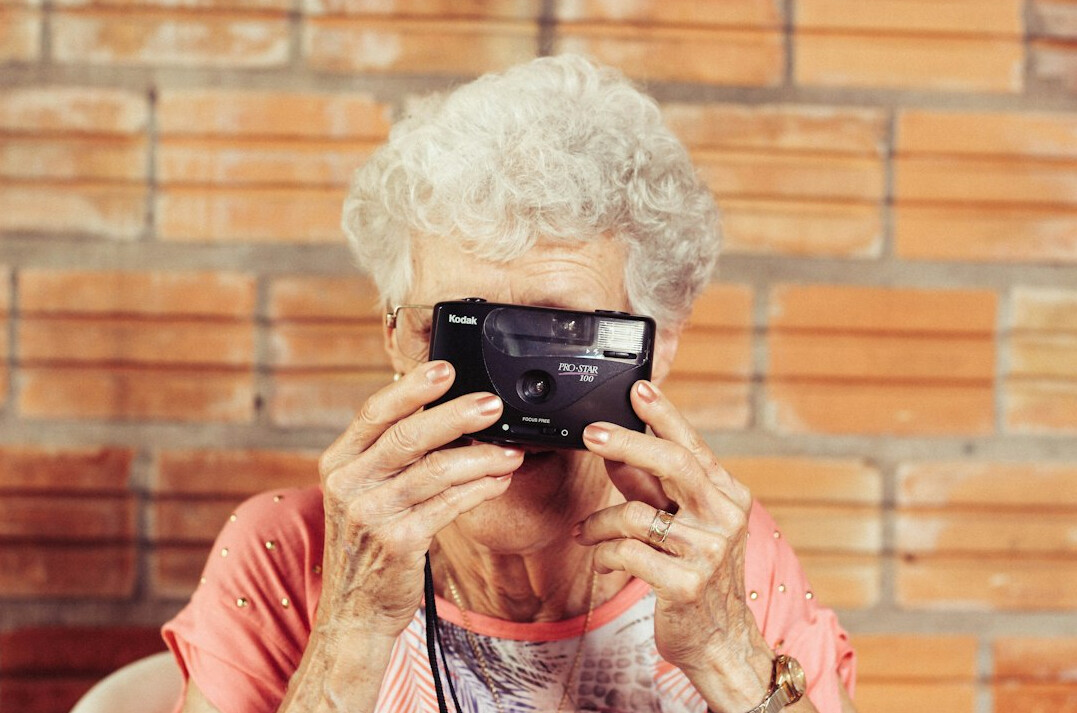 elderly woman holding photo